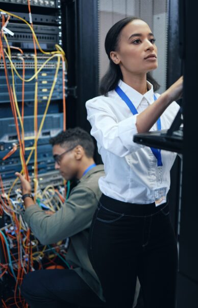 server-room-engineer-it-team-working-together-programming-cybersecurity-maintenance-african-woman-man-technician-datacenter-network-software-server-system-upgrade